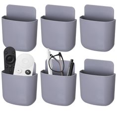 there are many cups and remotes in the cup holder with glasses on it, along with other items