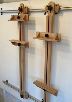 two wooden pegs are hanging on the wall