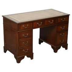 an antique desk with marble top and drawers