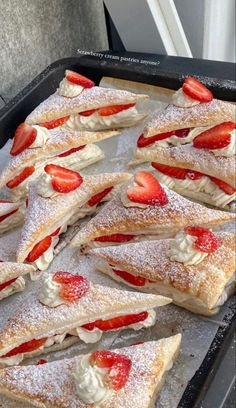 strawberry shortcakes with powdered sugar and fresh strawberries on top are ready to be eaten