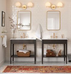 there are two sinks in the bathroom with mirrors on the wall and rug underneath them