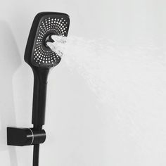 a shower head with water coming out of it's spout and spraying from the side