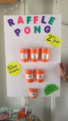 a sign that says raffle pong with cups on it and the numbers in each cup