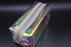 Store all of your necessities in style with this adorable transparent iridescent travel bag. Great for carrying your favorite products, the zip pouch has a holographic, transparent design that makes it a cute addition to everyone's beauty arsenal. Tip: Use it as a clutch while going out with friends Size: (approx) cm 19*9*9 Clear Pouch Cosmetic Bag As Gift, Clear Pouch Cosmetic Bag Gift, Iridescent Rectangular Bag For Gift, Clear Zipper Pouch Bag For Gift, Clear Zipper Pouch Bag As Gift, Going Out With Friends, Transparent Design, Zip Pouch, Favorite Products