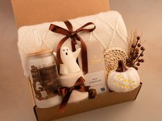 a gift box with candles, figurines and other items