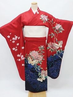 This Japanese wedding Furisode kimono featuring delicate pink and blue flowers & butterflies on a red background.  Wear this beautiful long sleeve robe on your wedding day or hang it as a display to admire daily. Item: Furisode Silk Kimono No. Syfu056 Size: US  XL   /  Length 65 inch (165cm), Width 26.75 inch (68cm). Design :  Floral  Condition: Used, Very Good. Please check the photos. Need a Obi Sash? Find it here: https://www.etsy.com/shop/KimonoFujiyamarock? Shop the entire collection https: Luxury Red Kimono With Kimono Sleeves, Elegant Red Kimono For Wedding, Traditional Red Kimono For Wedding, Chrysanthemum Kimono, Butterfly Kimono, Aztec Clothing, Kimono Styling, Furisode Kimono, Obi Sash