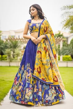 Blue attached cancan lehenga with animal and bird kalamkari hand painted patterns. Paired with  padded blue blouse embroidered with glass beads and kalamkari yellow dupatta with contrast border. - Aza Fashions Yellow And Blue Lehenga, Kalamkari Tops Designs, Kalamkari Lehangas Designs, Fitted Royal Blue Lehenga For Navratri, Designer Blue Lehenga With Motifs, Semi-stitched Blue Lehenga With Motifs, Blue Motif Anarkali Set For Wedding, Blue Anarkali Set With Motifs For Wedding, Blue Tilla Sets For Diwali