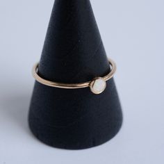 This dainty stacking ring is handmade in solid 14 karat gold. It features a tiny 4mm opal that has been bezel set. This ring is perfect to wear alone or stack with others. Please note that each opal is different and will not be exactly as shown. Want a customized gemstone option? Just reach out Handmade by Metrix Jewelry in New York. All products are made to order, please allow up to 2 weeks before shipping for 14 karat gold items. Contact Hello@MetrixJewelry.com if you require expedited service Custom Gemstone Rings, Opal Stacking Ring, Gemstone Stacking Ring, Gold Items, Opal Ring Gold, Stacking Ring, Opal Gemstone, Opal Rings, Earring Backs