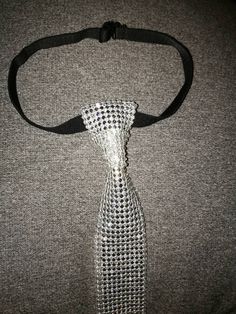 "Perfect for Christmas, New Years, Holidays, Weddings and any special occasion, or to dress up a shirt and pair of jeans. I designed this tie for the elegance in all of us and the fun loving person of all ages.  Add a touch of glam to your wardrobe and Sparkle to your day.   Neck size adjustable from 10\" to 18\" with a stretch to 20\".  Tie length varies around 24\" (61cm). Special order sizes available upon request.  (Add 10 days additional for shipping) Order soon for holiday delivery.  Shipp Elegant Silver Suit And Tie Accessories For Party, Elegant Adjustable Ties For Parties, Elegant Silver Tie As A Gift, Silver Tie As A Gift, Silver Tie For Gift, Silver Ties For Black Tie Occasions, Adjustable Silver Ties For Black Tie Events, Silver Party Tie, Tie Length