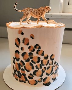 a cake with a cheetah figure on top of it