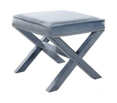 a stool with studded legs and a blue cushion