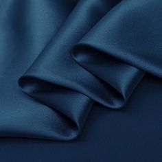 a close up view of a blue satin fabric