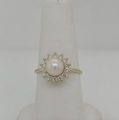 Exquisite 14k Gold Statement Ring: 7.2mm Pearl & .50ct Diamonds, Size 8.25. Discover timeless elegance with this stunning statement ring featuring a lustrous 7.2mm pearl at its center, surrounded by .50 carats of dazzling diamonds, all set in a classic basket-style design of 14k gold. Perfect for making a sophisticated statement. Formal White Pearl Ring With Center Stone, Classic Pearl Ring With Diamond, Classic Pearl Ring With Diamond Center Stone, Classic Pearl White Diamond Ring For Formal Occasions, Classic Pearl Ring With Brilliant Cut, Timeless Pearl Ring With Prong Setting For Formal Occasions, Timeless Formal Pearl Ring With Prong Setting, Classic Pearl White Rings With Brilliant Cut, 14k Gold Pearl Ring With Round Cut Center Stone