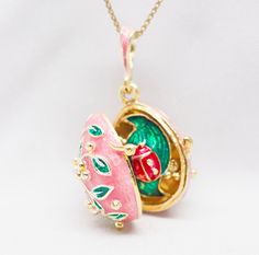 "Sterling silver jewelry locket, enameled and 24 K gold plated,  this  pendant  is designed and made in our NJ shop in the tradition of Faberge jewelry.  A red ladybug on a green leaf is fixed steadily inside the locket enameled with pink and green colors. I added a picture of the pendant in other color variations, which may be available upon request. The egg is 20 mm (0.7\") long without a bail for a chain.  It comes with 18' sterling silver gold plated chain. If you feel that you need a longer Pink Locket, Jewelry Locket, Egg Necklace, Ladybug Jewelry, Barbie Vibes, Faberge Jewelry, Strawberry Patch, Nouveau Jewelry, Jewelry Lockets