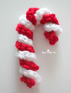 a red and white striped candy cane on a table