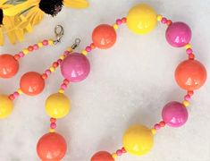 "30\" Brite Bubble Beaded Orange/Pink/Yellow Multi Lucite Necklace & Matching Cluster Clip On Earrings Pink/Yellow/Orange Alternating Beads with Mini Beads Large Beads Measure 3/4\" in Diameter Smaller Beads Measure 5/8\" in Diameter Silver Tone Lobster Clasp Cluster Clip On Earrings Measure 1 1/8\" in Diameter Made in USA Necklace/Earrings Set 42.00 Necklace Only 29.00 Cluster Earrings Only 15.00 COMPLIMENTARY DOMESTIC SHIPPING" Yellow Beaded Necklaces With Large Beads For Summer, Summer Yellow Beaded Necklaces With Large Beads, Yellow Round Bead Necklaces For Summer, Yellow Round Beads Necklace For Summer, Handmade Vibrant Yellow Jewelry, Vibrant Handmade Yellow Jewelry, Vibrant Yellow Handmade Jewelry, Adjustable Single Strand Yellow Beaded Necklaces, Adjustable Single Strand Yellow Beaded Necklace