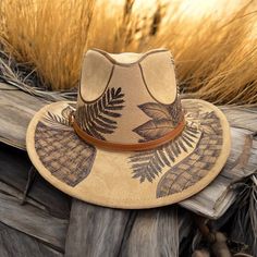 Burned Short Brim Cowboy in Camel. Burned using Pyrography techniques. Each Hat burned is a one of a kind. Hat is sprayed for weather and wear. Hat is adjustable for a tighter fit. All hats made by PIPER Hat Co. come with a signature dust bag & a macrame hat wall hanger. Pyrography Techniques, Macrame Hat, Hat Wall, Velvet Hat, Cowboy Hat, Pyrography, Hat Making, Wall Hanger, Bridal Accessories