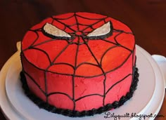 a spiderman cake on a white plate