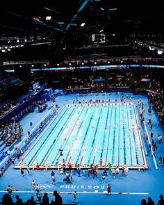 an olympic swimming pool is shown at night