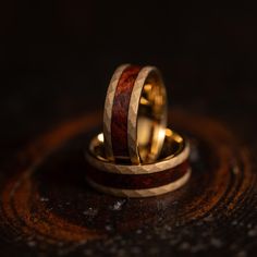 two gold wedding rings with wood inlays