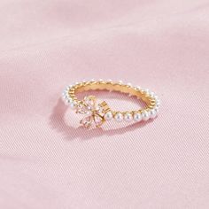 Complete any look with this beautifully crafted Maisie Crystal & Pearl Flower Ring. Designed to sparkle and shine all night long, this ring is perfect for any occasion. 18K gold plated, brass AAA cubic zirconia crystal Imitation freshwater pearl Hypoallergenic, lead & nickel free US/Canada Ring Size UK/AU Ring Size Inside Diameter (mm) 6 L 16.6mm 7 N 17.2mm 8 P 18.1mm If you aren't in LOVE with your purchase, please let us know within 30 days of receiving your item, and you'll receive a stress-f Gold Sparkling Rings For Wedding, Sparkling Gold Rings For Wedding, Wedding Rose Gold Plated Crystal Ring, Dainty Gold-plated Crystal Wedding Ring, Elegant Gold Crystal Ring Sparkling, Elegant Gold Crystal Ring With Sparkling Detail, Dainty Gold Plated Crystal Wedding Ring, Cubic Zirconia Yellow Gold Flower Ring, Gold Elegant Flower Ring For Promise