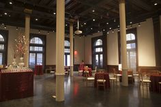 an empty banquet hall with tables and chairs set up for a formal function in front of large windows