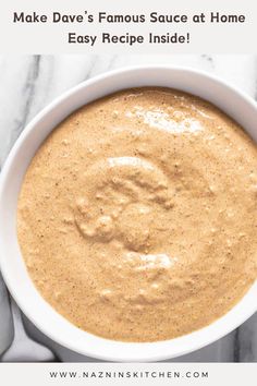 a white bowl filled with sauce sitting on top of a marble counter