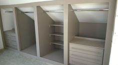 an empty walk in closet with drawers and shelves