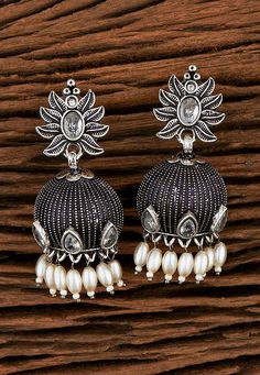 Oxidised Stone Studded Jhumka Style Earrings  Alloy Based Jhumka Style Earrings in Silver, This Oxidised pair is Allured with Stones and Artificial Pearls, Stones and Pearls Studded Tribal Design Oxidised Silver Plated Handcrafted Jhumkas, Secured with a Post and Back.  About The Product: Oxidised Stone Studded Jhumka Style Earrings Length and Width is 2 and 1 inches respectively. Oxidised earring gives the jewelry an antique or tarnished look  Dimensions:  Width is 2  1 inches   Key Benefits  Light in weight  Wear in any Occasion    Legal Disclaimer:  The product is guaranteed to be 100% genuine. Product images are for illustrative purposes only. Images/packaging/ labels may vary from time to time due to changes made by the manufacturer's manufacturing batch and location. The product desc Traditional Oxidized Jhumkas For Diwali, Bollywood Oxidized Finish Jhumkas For Wedding, Oxidized Temple Jewelry Jhumkas For Festivals, Bollywood Style Oxidized Jhumkas For Festive Occasion, Traditional Oxidized Finish Jhumkas Drop Earrings, Traditional Oxidized Jhumkas Drop Earrings, Oxidized Finish Jhumkas For Diwali Festival, Diwali Oxidized Finish Drop Jhumkas, Traditional Oxidized Drop Earrings Jhumkas