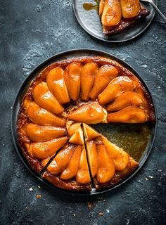 an upside down cake on a plate with slices cut out and ready to be eaten