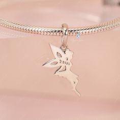 This is charm only, bracelet is sold separate. Enhance your jewelry collection with the addition of this charming pixel fairy pendant charm. Made of solid 925 sterling silver with a platinum plating and adorned with cubic zirconia decoration, this elegant fairy elf design is sure to capture your heart. Add it to your bracelet or necklace, or give it as a gift to a loved one to add a touch of magic and sparkle to their daily wear. Experience the enchantment of this exquisite fairy charm, beautifu Whimsical Silver Charms For Gifts, Whimsical Sterling Silver Charms Jewelry, Whimsical Silver Dangling Charms, Silver Pendant Charms With Cubic Zirconia, Silver Cubic Zirconia Pendant Charms, Elegant Sterling Silver Butterfly Charm, Fairy Style Sterling Silver Jewelry, Fairy Style Silver Jewelry For Gift, Whimsical Silver Jewelry With Butterfly Charm