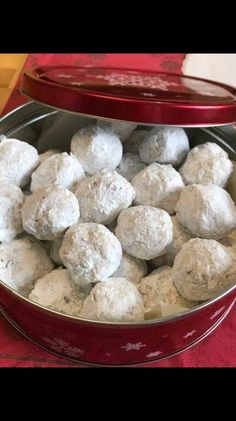 a red tin filled with snowballs sitting on top of a table