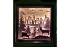 paper cut art depicting deer in the woods with santa's sleigh and reindeer