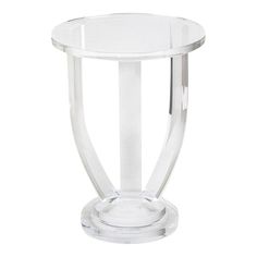 a clear glass vase sitting on top of a white table