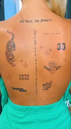 the back of a woman with tattoos on her upper and lower back, which are written in different languages