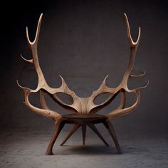 an antelope sculpture sitting on top of a wooden table