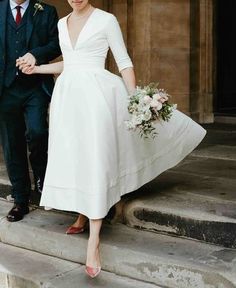 a bride and groom walking down the steps