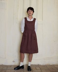 Our Pinafore dress is designed to be a versatile member of your closet, with front pockets and buttoning shoulder straps, wear it over dresses, sweaters, or while you are creating, making, gardening, baking. Crafted to a high standard in California from sustainably grown, medium weight European linen. DETAILS Dress Features:- A deep neckline with buttoning shoulder straps- An adjustable waist tie (the back of the dress has two small belt loops and a removable tie)- Front pockets Fabric: 100% pre Vintage Pinafore Dress, Pinafore Dress Pattern, Wool Leg Warmers, British Uniforms, Ginger Dress, Small Belt, Autumn Winter 2024, Cropped Linen Pants, Deep Neckline