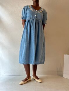 - Vintage button up denim dress - 100% cotton - Made in India - Tagged M Bust: 20" Length: 44.5" We are not responsible for lost, stolen, or damaged packages once they have been shipped. Any additional customs duties or taxes incurred on international orders are the responsibility of the buyer. Please note that our items are vintage and may have minor flaws or imperfections due to their age, which adds to their unique character. Denim Blue Cotton Dress With Buttons, Washed Blue Cotton Denim Dress With Button Closure, Washed Blue Denim Dress With Button Closure, Button-up Denim Blue Cotton Dress, Denim Blue Cotton Button-up Dress, Blue Cotton Denim Dress With Buttons, Washed Blue Cotton Dress With Button Closure, Washed Blue Cotton Dress With Short Sleeves, Summer Button-up Cotton Denim Dress