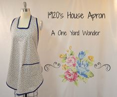 a dress on display next to a sign that says, 1920's house apron at one yard wonder