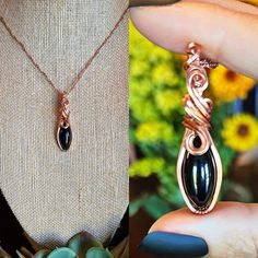 "Beautiful Black Obsidian wrapped in copper wire with tarnish resistant coating and a copper 20\" chain." Unique Black Copper Jewelry, Black Copper Pendant Jewelry, Handmade Black Copper Necklaces, Handmade Black Copper Necklace, Black Copper Pendant Necklace, Black Copper Wire Hand Wrapped Necklaces, Black Copper Wire-wrapped Necklace, Black Copper Wire Pendant Necklaces, Elegant Black Copper Jewelry