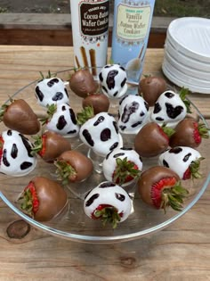 chocolate covered strawberries are arranged on a glass plate