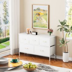 a living room filled with furniture and a painting on the wall over a white coffee table