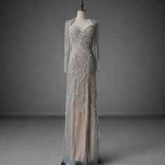 an evening gown with long sleeves and sequins