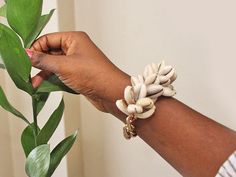 The bracelet that makes every outfit better, thanks to clusters of cowrie shells, Elastic bracelet Weathered, rustic gold clad link One size fits most Krobo Beads, Accessorize Jewellery, Cluster Bracelet, Cluster Bracelets, Cowrie Shells, Inspirational Bracelets, Natural Beauty Tips, Cowrie Shell, Elastic Bracelet