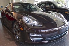 two porsches are parked in a showroom