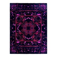 a purple and black area rug with an intricate design on the center, surrounded by small pink flowers