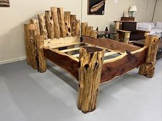 a bed made out of wooden logs in a room