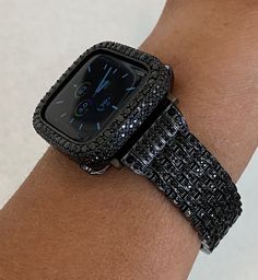 Fits the Apple Watch available for sizes 38,40,41, 42,44 and 45mm in series 1,2,3,4,5,6,7 or SE Men's & Women's. This beautiful Black Apple watch band is high on the bling with a stainless steel band that features rows of high quality lab diamonds Add the matching bezel for an over the top Holiday Party Accessory. Exclusive Iwatch Candy Design. ⚬ Fits wrist sizes 5.5" to 8" ⚬ Classic butterfly closure. ⚬ Comes with an easy to use link removal tool and instructions. Add the Apple Watch Bezel or s Apple Watch Cover, Black Apple Watch, Black Apple Watch Band, Custom Apple Watch Bands, Holiday Party Accessories, Bracelet Apple Watch, Ceramic Watch, Apple Watch Case, Black Apple