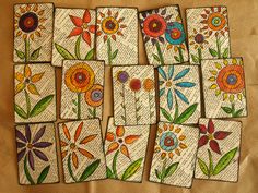 six coasters with flowers painted on them sitting on top of a piece of paper